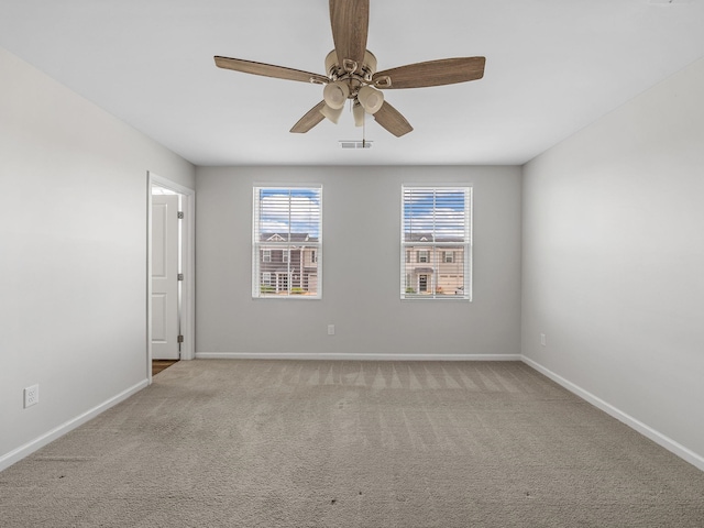 unfurnished room featuring healthy amount of natural light, baseboards, and light carpet