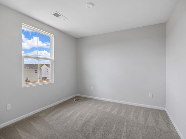 carpeted empty room with baseboards