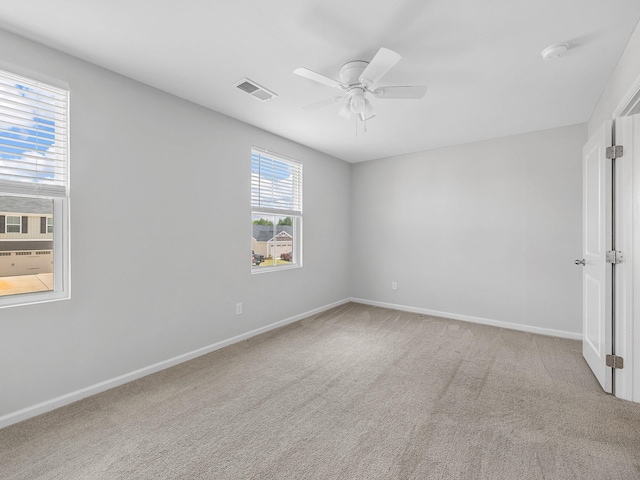 empty room featuring ceiling fan, carpet flooring, and baseboards