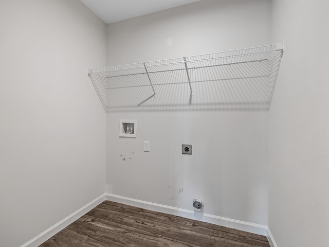 clothes washing area with electric dryer hookup, hookup for a washing machine, dark wood finished floors, and baseboards