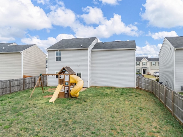 rear view of house featuring a playground and a residential view