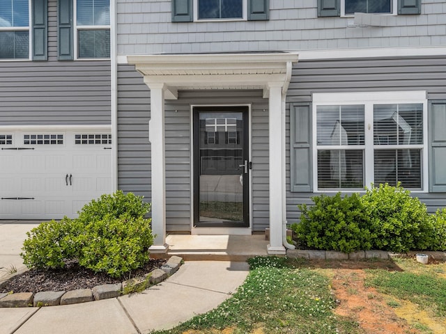 doorway to property featuring an attached garage