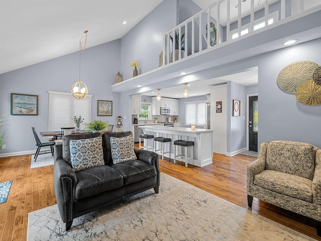 702 Lakewinds, Inman, SC 29349 - living room with high vaulted ceiling, light wood finished floors, baseboards, a chandelier, and recessed lighting