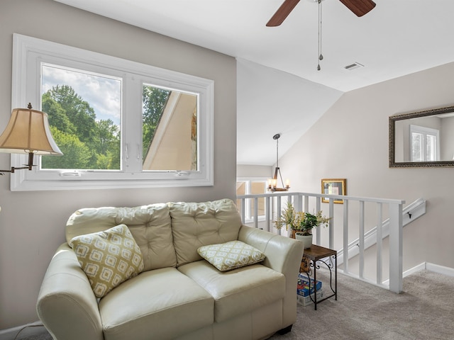 702 Lakewinds, Inman, SC 29349 - carpeted living area featuring healthy amount of natural light, a ceiling fan, vaulted ceiling, a chandelier, and baseboards