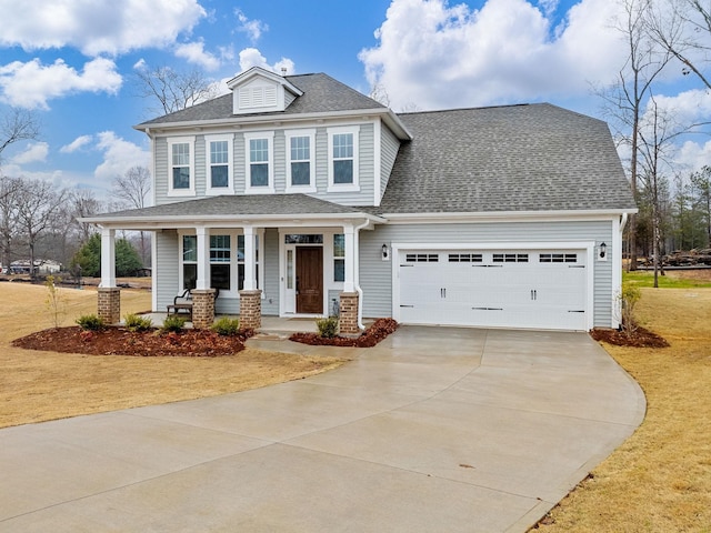 view of front of house featuring covered porch, driveway, a garage, roof with shingles, and a front lawn