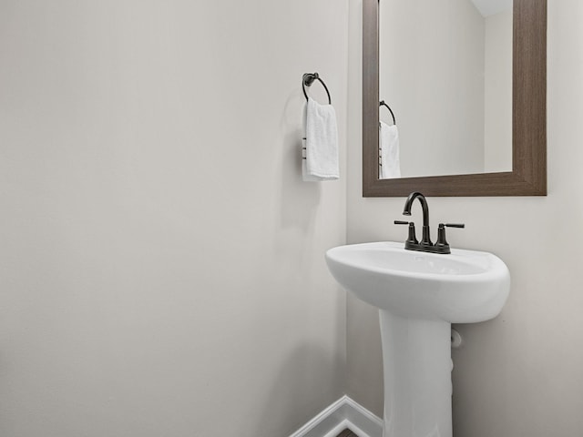 bathroom with baseboards and a sink