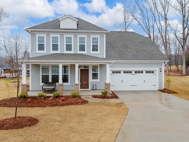 view of front of house with a porch, concrete driveway, a garage, and roof with shingles