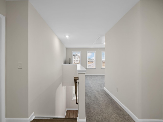 corridor with an upstairs landing, attic access, baseboards, carpet floors, and recessed lighting