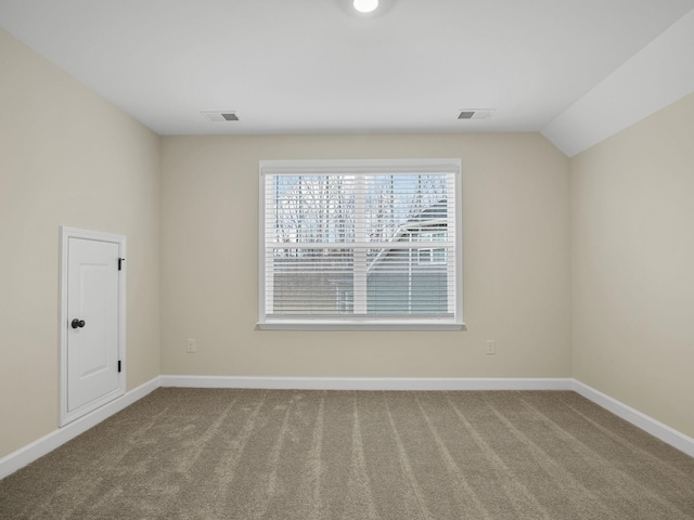 unfurnished room featuring carpet flooring, baseboards, and vaulted ceiling