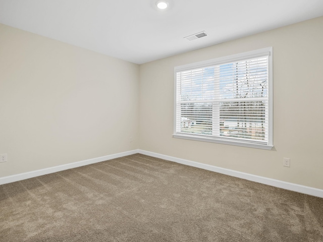 spare room with carpet flooring and baseboards