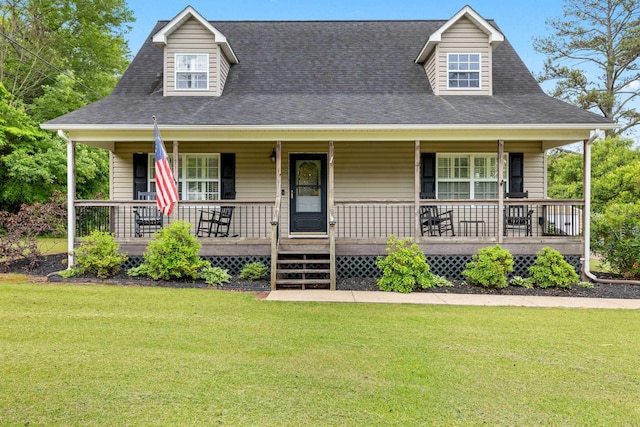 view of front of home featuring a front lawn, covered porch, and a shingled roof