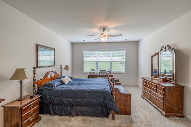 bedroom featuring light carpet, baseboards, and a ceiling fan