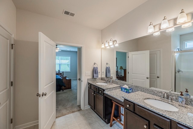 ensuite bathroom featuring double vanity, tile patterned floors, baseboards, an enclosed shower, and ceiling fan
