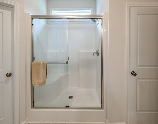 bathroom featuring a shower stall