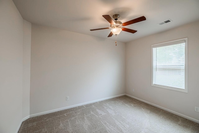 unfurnished room with light carpet, ceiling fan, and baseboards