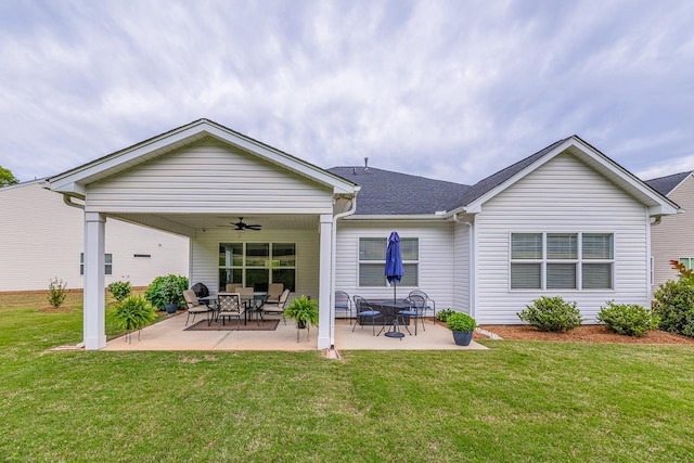 rear view of house featuring ceiling fan, a lawn, and a patio