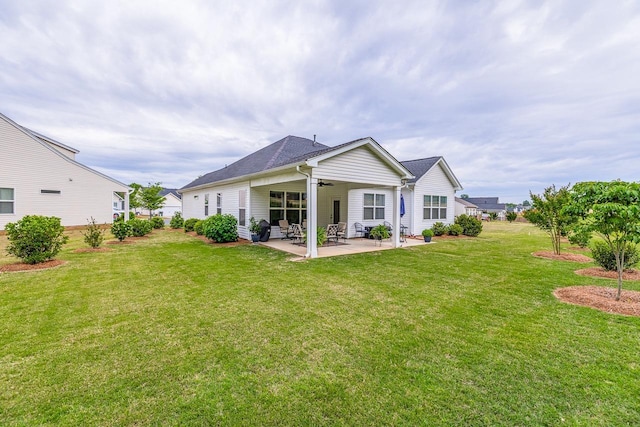 back of property with ceiling fan, a patio, and a lawn