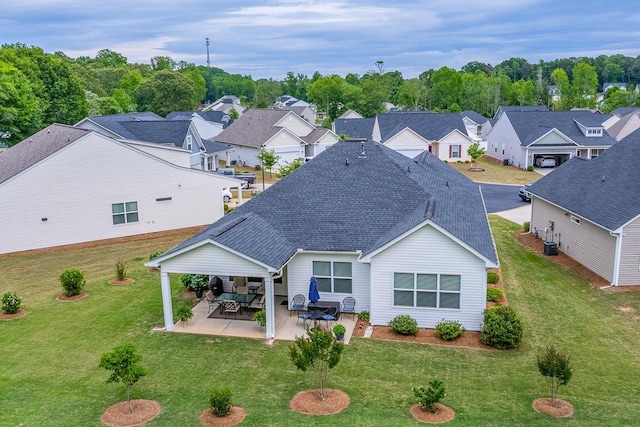 back of property featuring roof with shingles, central AC, and a yard