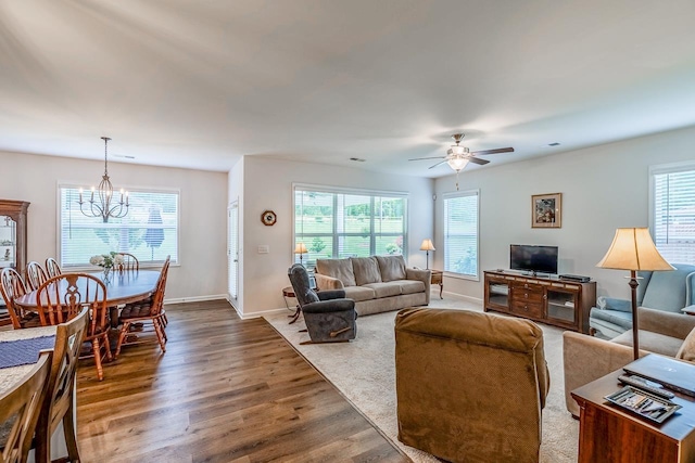 living area with a chandelier, wood finished floors, ceiling fan, and baseboards