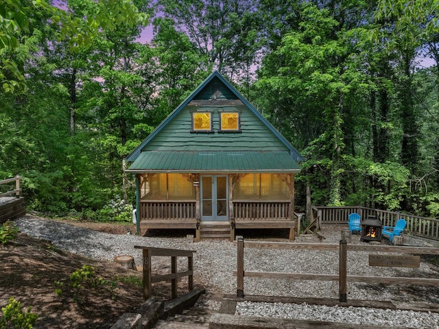 18 Lennox, Landrum, SC 29356 - back of house with a fire pit, covered porch, metal roof, and french doors