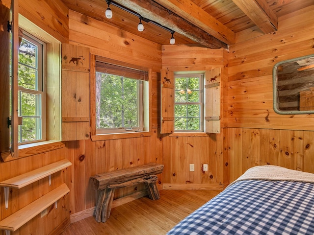 18 Lennox, Landrum, SC 29356 - bedroom featuring light wood-style flooring, beam ceiling, wood walls, and rail lighting