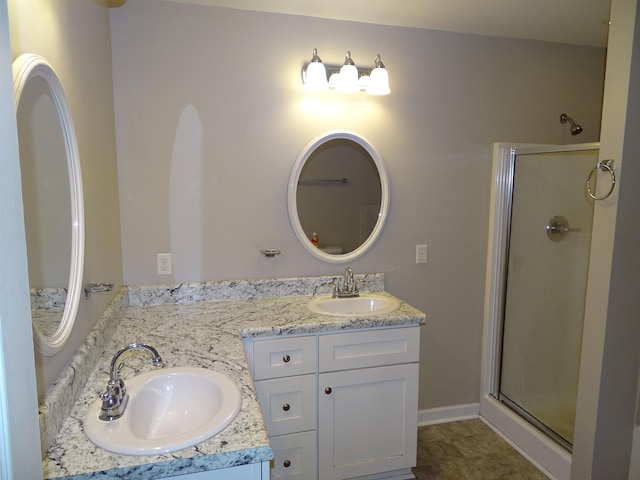 full bath featuring a shower stall and double vanity