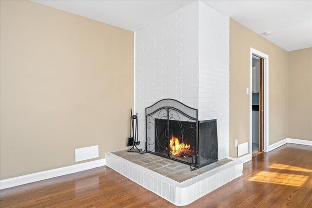 222 Woodview, Spartanburg, SC 29306 - detailed view of a brick fireplace, wood finished floors, and baseboards