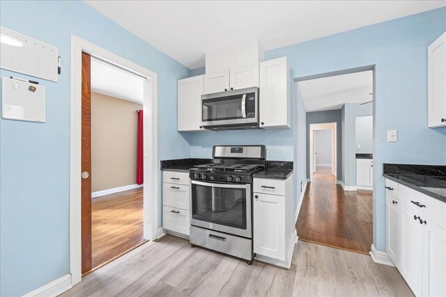 222 Woodview, Spartanburg, SC 29306 - kitchen featuring stainless steel appliances, light wood finished floors, white cabinetry, and baseboards
