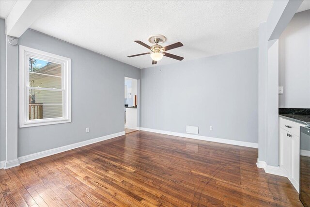 222 Woodview, Spartanburg, SC 29306 - unfurnished living room with a ceiling fan, dark wood-style floors, baseboards, and a textured ceiling