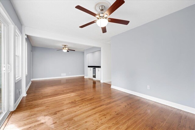222 Woodview, Spartanburg, SC 29306 - unfurnished living room with ceiling fan, baseboards, and light wood-type flooring