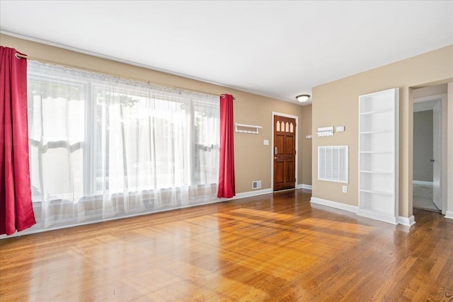 222 Woodview, Spartanburg, SC 29306 - unfurnished living room with wood finished floors, built in features, and baseboards