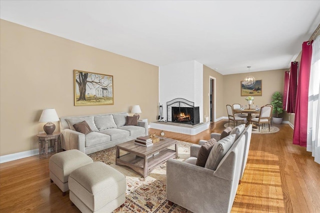 222 Woodview, Spartanburg, SC 29306 - living room with light wood-style floors, a chandelier, a multi sided fireplace, and baseboards