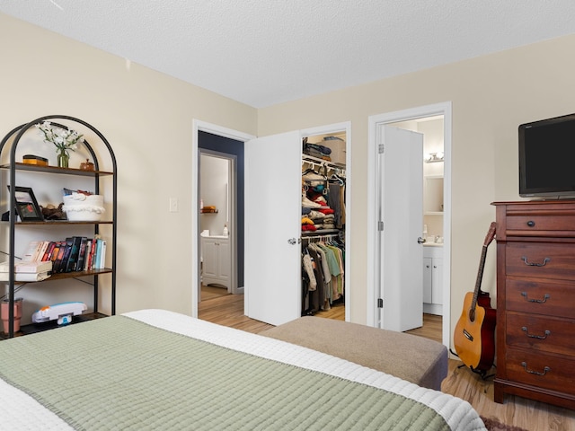 250 E Blackstock, Enoree, SC 29335 - bedroom with light wood-style floors, a walk in closet, a closet, and connected bathroom