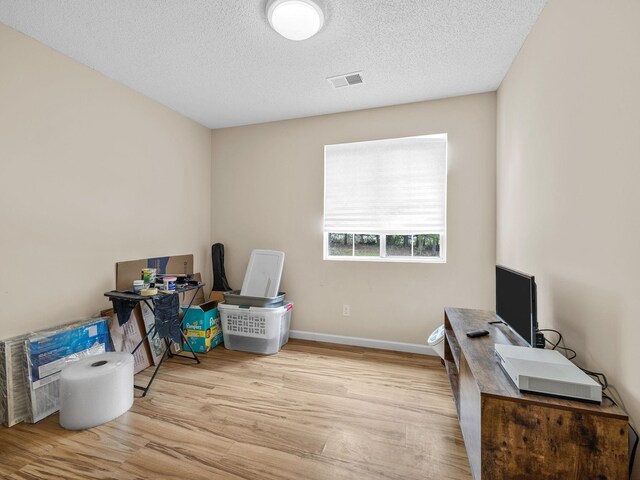 250 E Blackstock, Enoree, SC 29335 - unfurnished office featuring wood finished floors, a textured ceiling, and baseboards