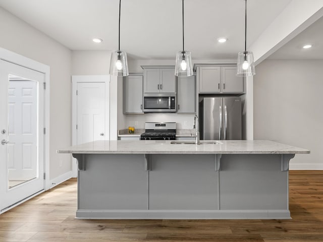 421 Hazelcote, Greenville, SC 29617 - kitchen featuring stainless steel appliances, gray cabinetry, a sink, a large island with sink, and a kitchen breakfast bar