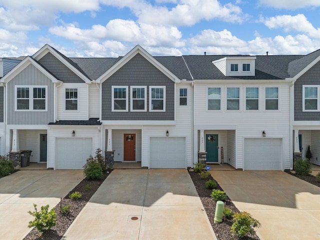421 Hazelcote, Greenville, SC 29617 - townhome / multi-family property featuring driveway, board and batten siding, roof with shingles, and a garage