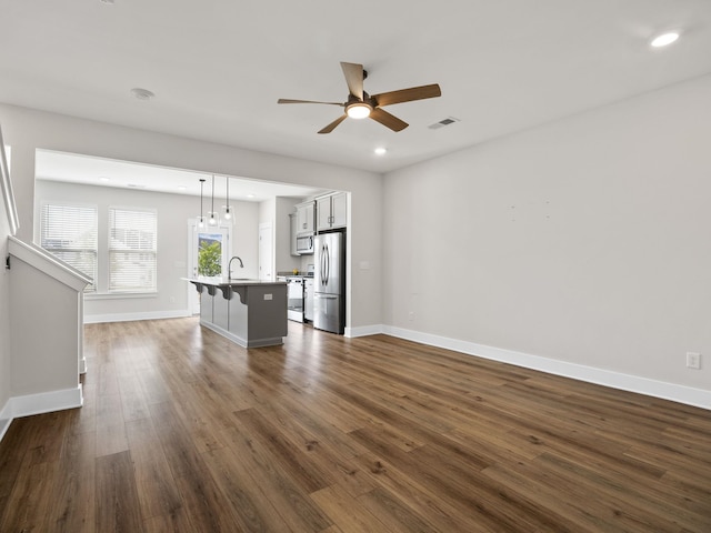 421 Hazelcote, Greenville, SC 29617 - unfurnished living room featuring a ceiling fan, a sink, dark wood-style flooring, baseboards, and recessed lighting