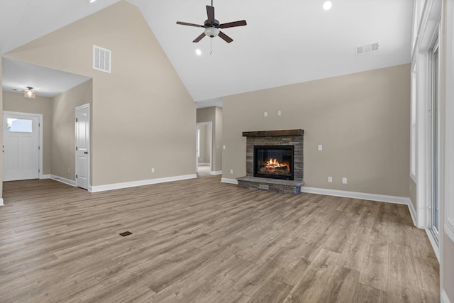21 Old, American, Pendleton, SC 29670 - unfurnished living room with high vaulted ceiling, ceiling fan, baseboards, a stone fireplace, and light wood-style flooring