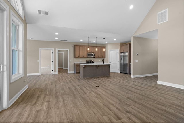 21 Old, American, Pendleton, SC 29670 - kitchen featuring stainless steel appliances, open floor plan, wood finished floors, a center island with sink, and recessed lighting
