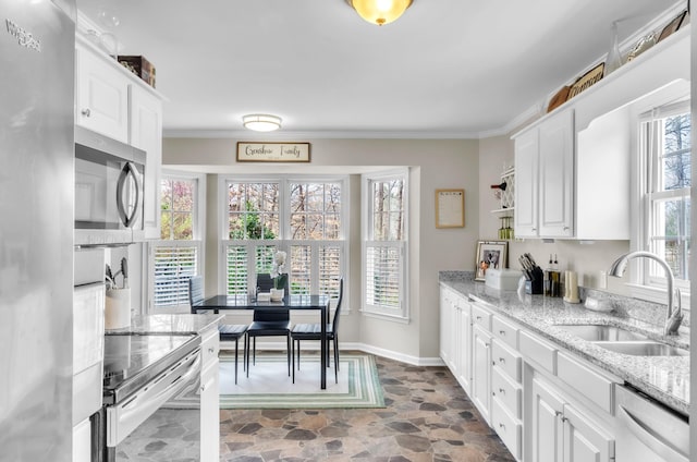 106 Rockport, Pacolet, SC 29372 - kitchen featuring a sink, appliances with stainless steel finishes, dark stone finish floors, white cabinets, and crown molding