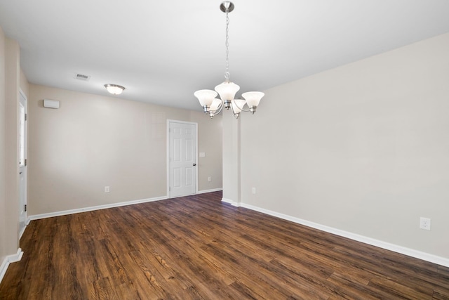 325 Victory, Moore, SC 29369 - unfurnished room featuring a chandelier, dark wood-style flooring, and baseboards