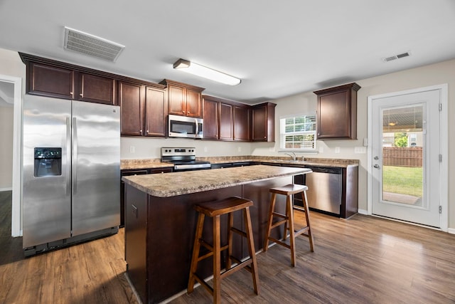 325 Victory, Moore, SC 29369 - kitchen with appliances with stainless steel finishes, dark wood finished floors, a center island, and dark brown cabinetry