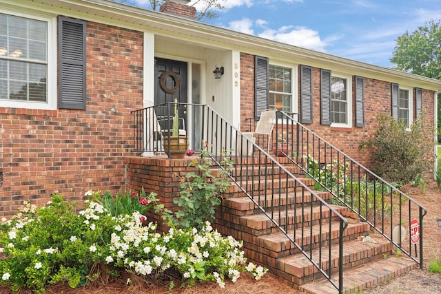 302 Peach Vly, Spartanburg, SC 29303 - property entrance with brick siding and a chimney