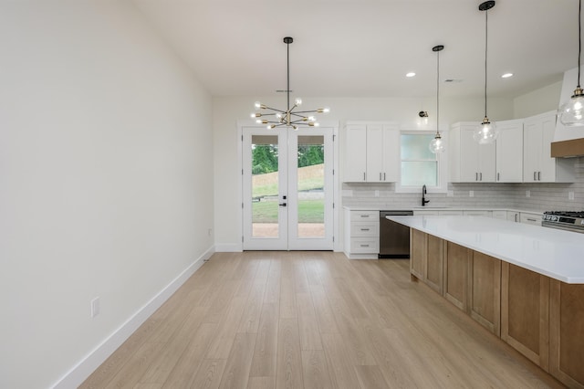 123 Stribling, Spartanburg, SC 29301 - kitchen with appliances with stainless steel finishes, light wood-style flooring, light countertops, decorative backsplash, and recessed lighting