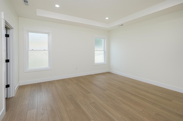 123 Stribling, Spartanburg, SC 29301 - unfurnished room with a tray ceiling, light wood finished floors, baseboards, and recessed lighting