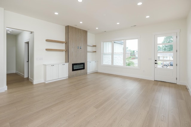 123 Stribling, Spartanburg, SC 29301 - unfurnished living room with a large fireplace, light wood-type flooring, recessed lighting, and baseboards