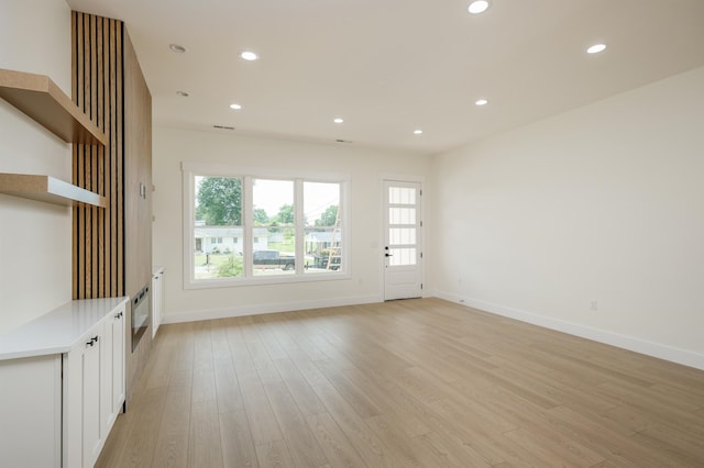 123 Stribling, Spartanburg, SC 29301 - unfurnished living room featuring light wood-style floors, baseboards, plenty of natural light, and recessed lighting