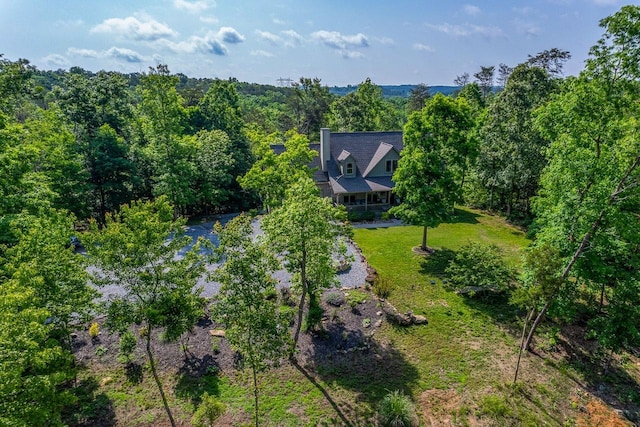 aerial view of property and surrounding area with a forest