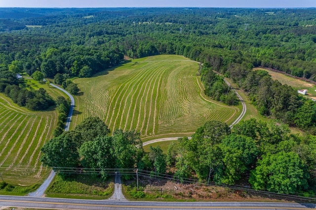 aerial overview of property's location with a heavily wooded area