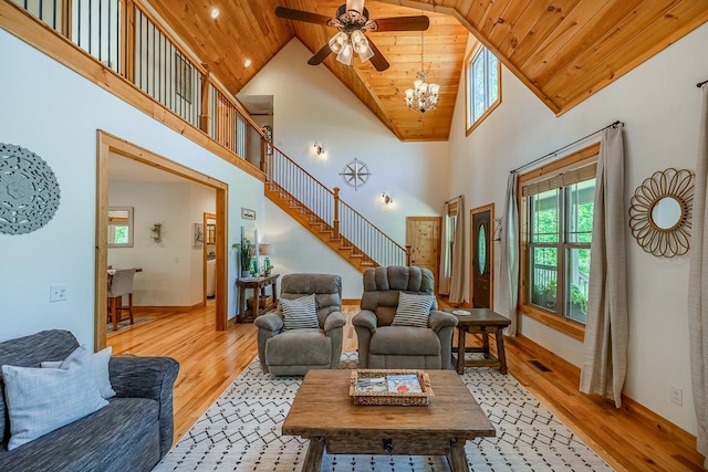 living area with wooden ceiling, light wood-type flooring, a chandelier, high vaulted ceiling, and a ceiling fan